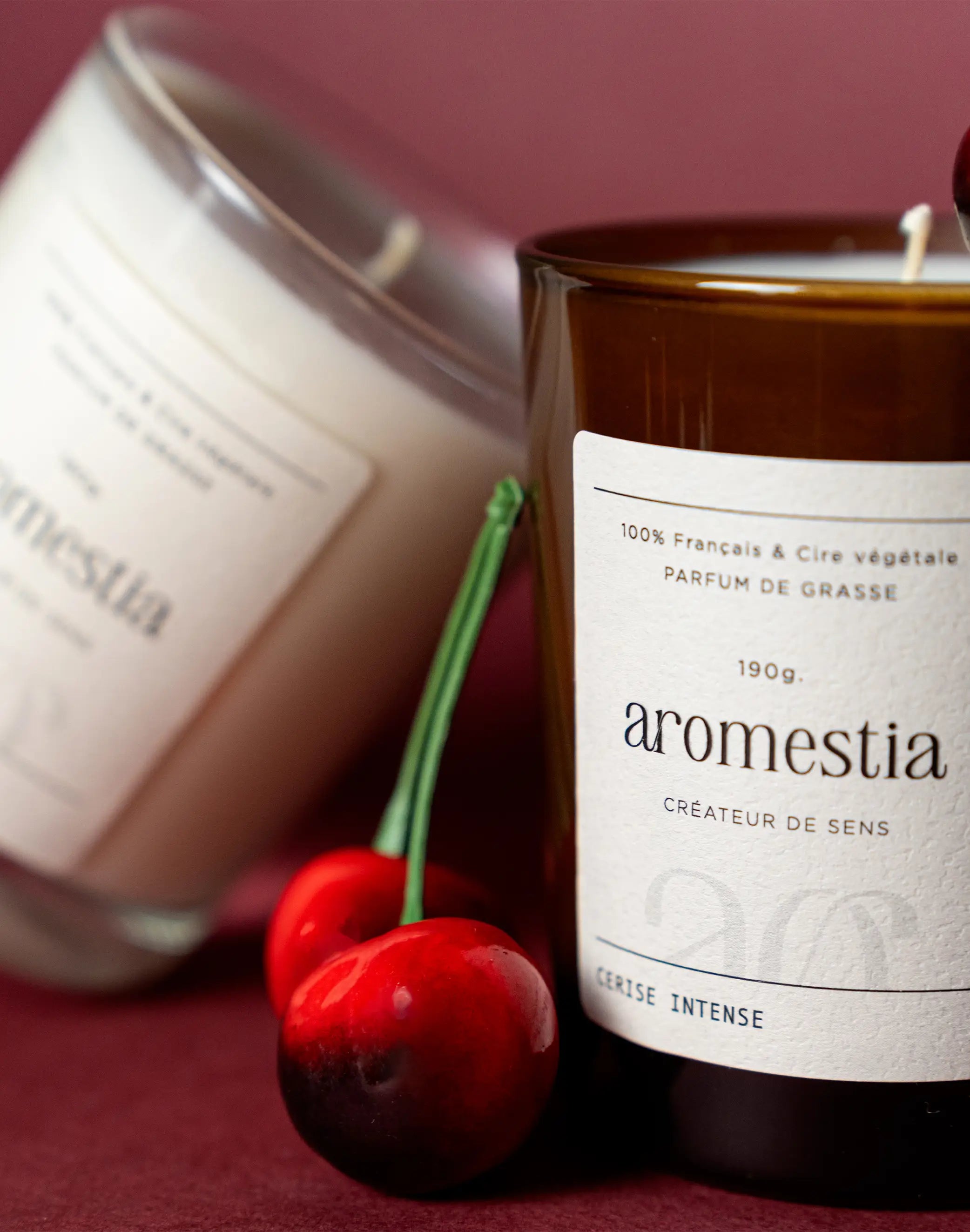 Bougie cerise intense contenants ambré et transparent