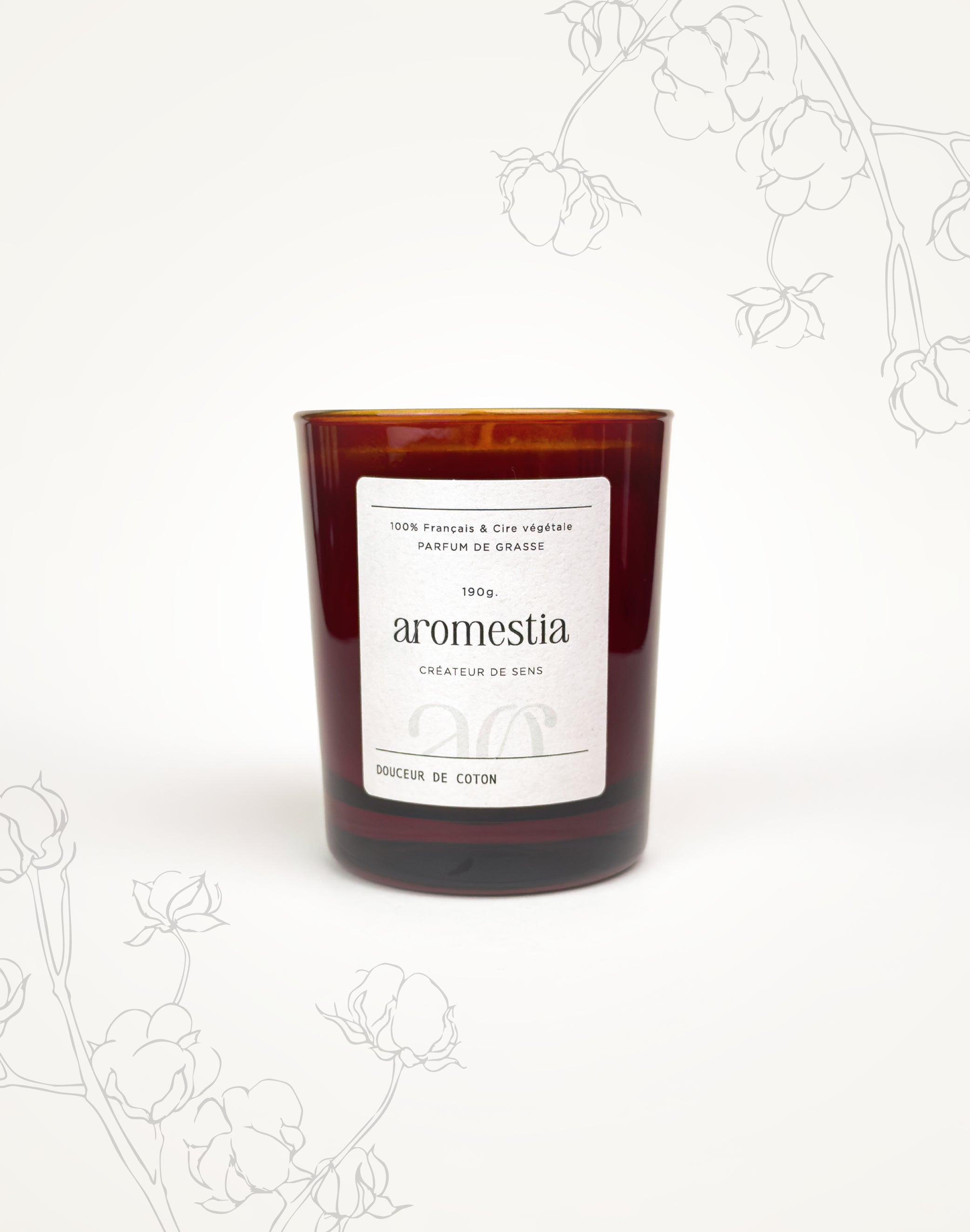 Présentation de la bougie fleur de coton Aromestia avec un contenant ambré